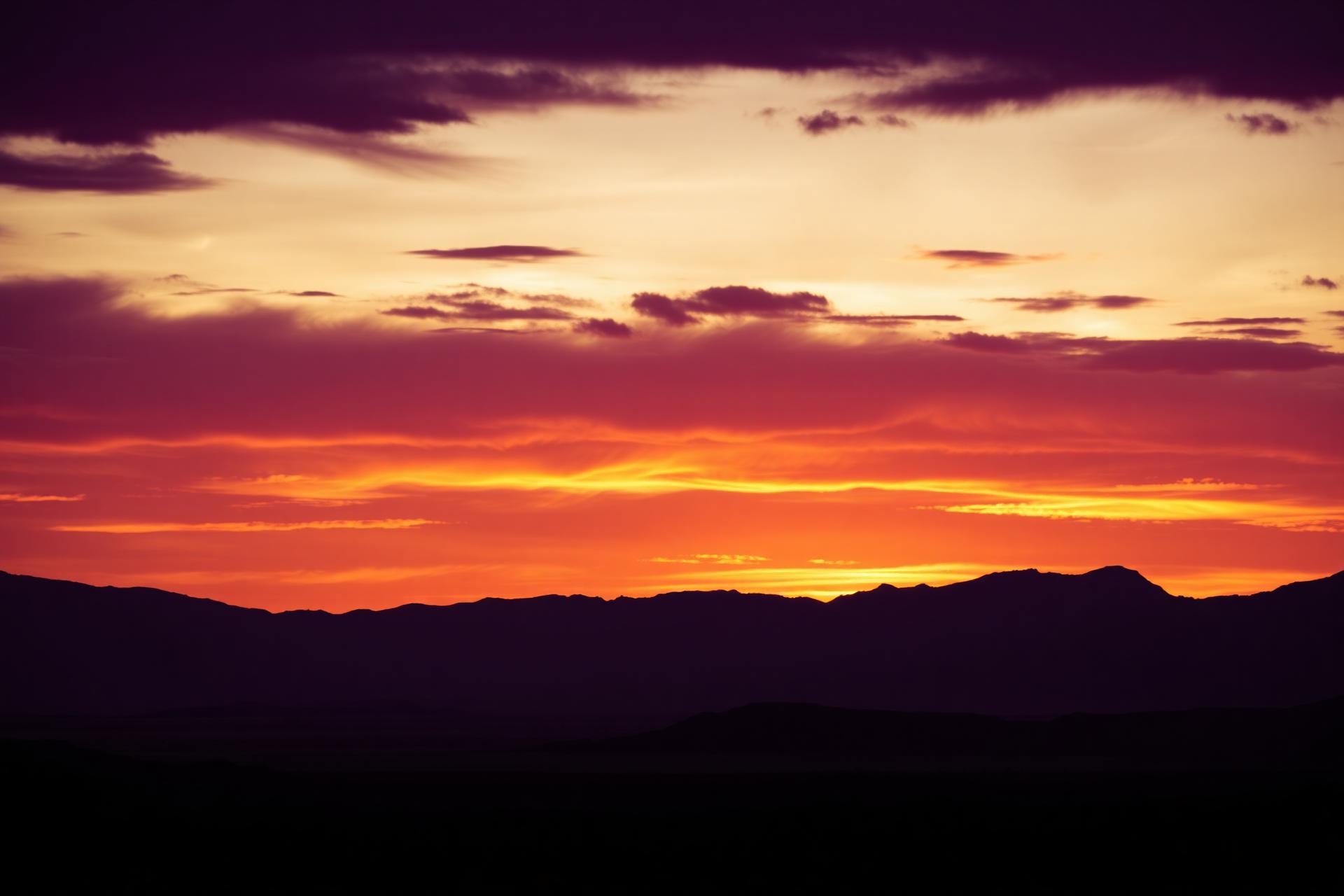 Desert valley sunset over mountain ridges